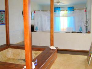a room with a bed and a window with a bed at Villa Los Gorgones in Las Galeras +36 photos