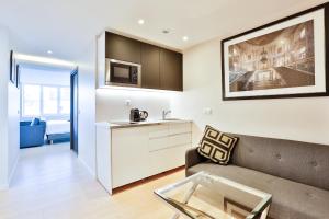 a living room with a couch and a table at Blue Nights Apartments - Sébastopol in Paris