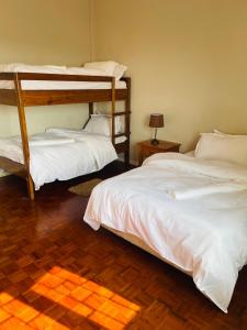 Postel nebo postele na pokoji v ubytování Januario Maputo