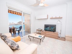- un salon avec un canapé, une télévision et une table dans l'établissement Frente al Mar con Garaje y Wifi - by Aloha Palma, à Águilas