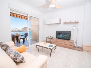 a living room with a couch and a tv and a table at Frente al Mar con Garaje y Wifi - by Aloha Palma in Águilas