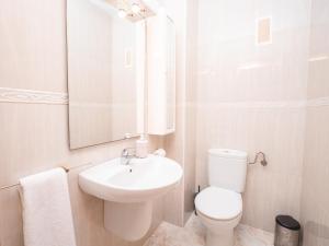 a bathroom with a sink and a toilet and a mirror at Frente al Mar con Garaje y Wifi - by Aloha Palma in Águilas +17 photos