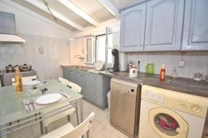 a kitchen with a washing machine and a sink at Villa Nirvana in Halikounas with private pool in Halikounas