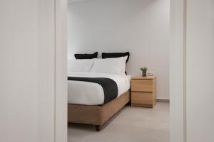 una camera con letto e comodino in legno di Athenian Riviera Secluded Apartment ad Atene