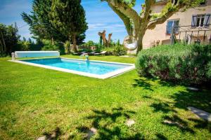 - une piscine dans la cour d'une maison dans l'établissement Appartement d'une chambre avec piscine partagee jacuzzi et jardin clos a Avignon, à Avignon