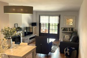 a living room with a table and a dining room at Badaguas It's Cozy in Badaguás