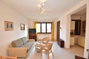 a living room with a couch and a table at Trilocale Lacona Mare - Zona mare con clima e posto auto in Lacona