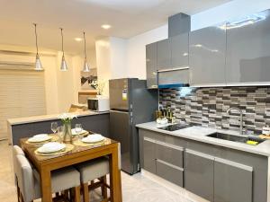 a kitchen with a table and a sink and a counter at Luxury Suite near Clark International Airport in Angeles