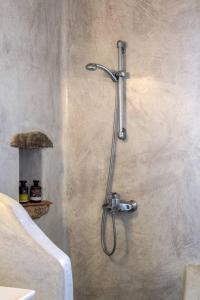 a shower in the corner of a bathroom at Luxury White Oasis Villa w Private Pool in Mikonos in Kalafatis