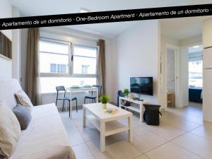 a living room with a couch and a table at Tusity Yeah Apartments in Las Palmas de Gran Canaria
