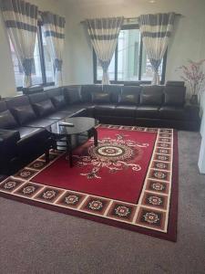 a living room with a black couch and a red rug at New house in Kathmandu