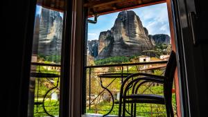 a view of the mountains from a window at Rooms Batalogianni in Kalabaka