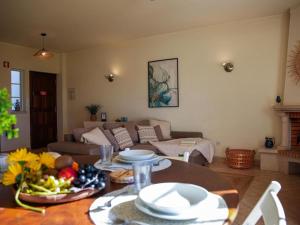 a living room with a table and a couch at Joia da Galé House - Pool and Garden & BBQ & Galé Beach in Albufeira