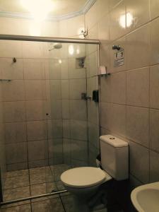 a bathroom with a toilet and a shower at Hostel Rotor in Ouro Branco +14 photos