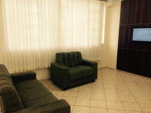 a living room with a couch and a chair at Hostel Rotor in Ouro Branco