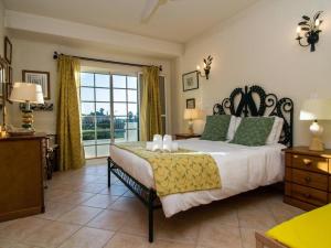 een slaapkamer met een groot bed en een groot raam bij Joia da Galé House by Stay ici Algarve Holiday Rental in Albufeira +26 foto's