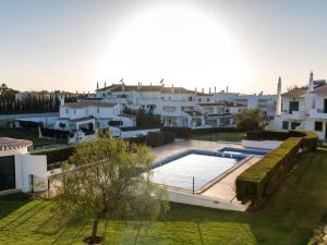 a large swimming pool in a yard with white buildings at Joia da Galé House - Pool and Garden & BBQ & Galé Beach in Albufeira