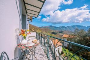 a table on a balcony with a view of mountains at Lucy's guest house Amalfi coast in Tramonti
