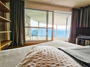 a bedroom with a bed and a view of the ocean at Turm Chalet in Laces