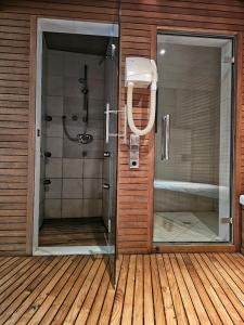 a bathroom with a shower and a glass door at Turm Chalet in Laces