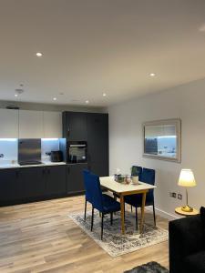 a kitchen and dining room with a table and chairs at The Velvet Vista in Croydon