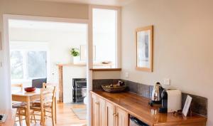 a kitchen with a wooden counter top and a table at Piermont Retreat in Swansea