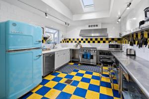 a kitchen with a blue refrigerator and a checkered floor at Bluemoon Vacation Rentals - Bluemoon House in Ashland
