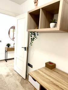 una cocina con estanterías de madera y una puerta en Alojamiento Bruckner, en Málaga