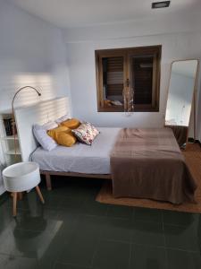 - une chambre avec un grand lit et un miroir dans l'établissement Villa Isabelita, piscina privada y salida a playa, à Tavernes de Valldigna