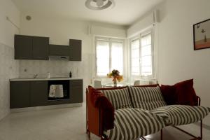 a living room with a couch and a kitchen at Casa dell'Opera in Pesaro +13 photos