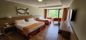 Cama ou camas em um quarto em Xelena Hotel & Suites