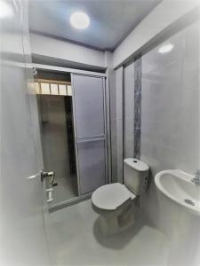 uma casa de banho branca com um WC e um lavatório em Apartaestudios White And Grey em Popayán