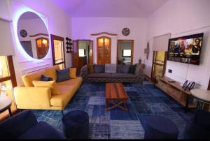 a living room with a couch and a table at Pelazzi Çiftliği - Farm House in Bozcaada