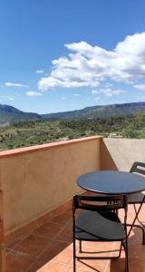stół i 2 krzesła na balkonie z widokiem w obiekcie Ca lAixut Turismo Rural w mieście Gratallops
