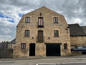 an old brick building with windows on a street at Luxury Studio Suite in Stamford Centre - The Old Seed Mill - B in Stamford