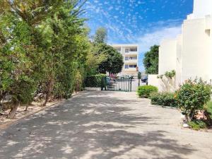 a street in front of a building with trees at Albufeira Sol Villas V - Pool and Garden & Gym & SPA in Albufeira