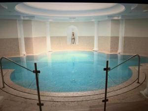 a large swimming pool with a woman standing in the background at 67 Croisette YourHostHelper in Cannes