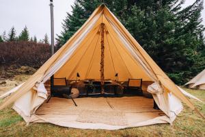 a tent with a table and chairs in it at Luxury Boutique Camping in Selfoss