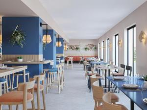 a restaurant with blue walls and tables and chairs at Tanka Selected in Villasimius