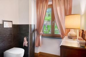 a bathroom with a toilet and a window at Ca' du Re in Chiavari +37 photos