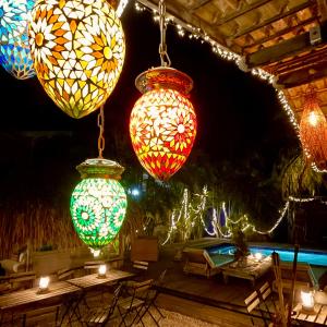a group of colorful lights hanging from a roof at Casa Calexico in Kralendijk