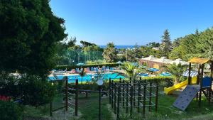 a resort with a swimming pool and a playground at Camping Villaggio Internazionale in San Menaio