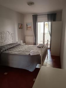 a large bed in a room with a window at Da Carlotta in Castel di Sangro