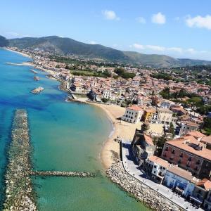 an aerial view of a town with a beach at Castellabate House in Santa Maria di Castellabate