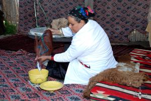 a woman sitting on the floor with a yellow bucket at Dar Zaghouan in Zaghouan
