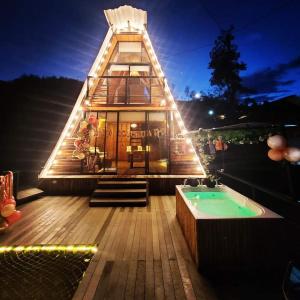 a house with a small pool in front of it at Glamping y Cabañas Alpina in Buga