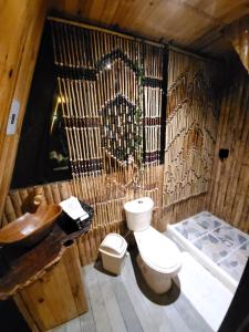 a bamboo bathroom with a toilet and a sink at Glamping y Cabañas Alpina in Buga +58 photos