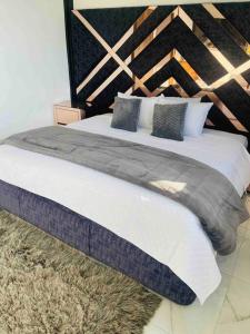 - une chambre avec un grand lit et une tête de lit en bois dans l'établissement Casa Blanca Cabaña de lujo rodeada de naturaleza, à Copacabana