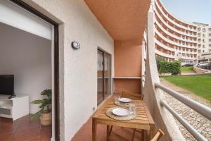 a balcony with a table with plates on it at Albufeira Haven 103 in Albufeira