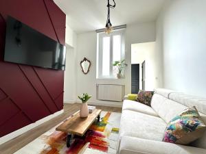 a living room with a couch and a table at Chez Alexia et Vincent in Lille